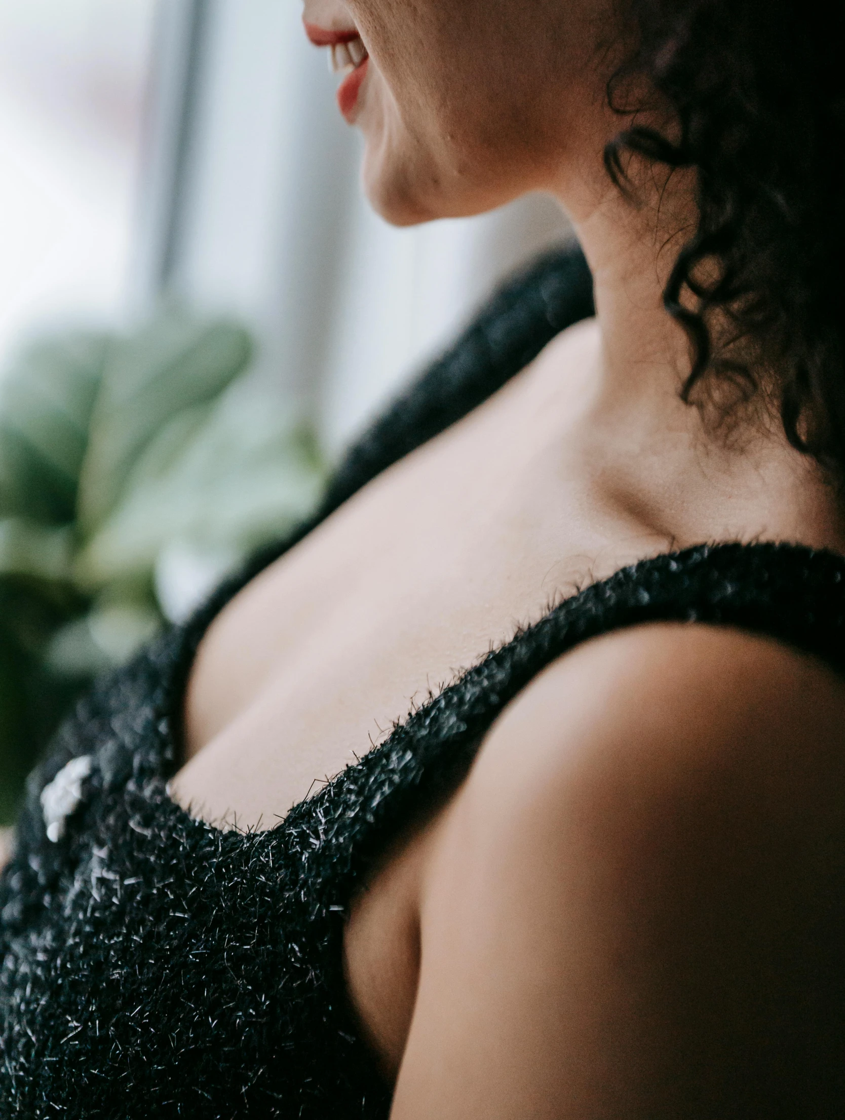 a close up of a person wearing a dress near a plant