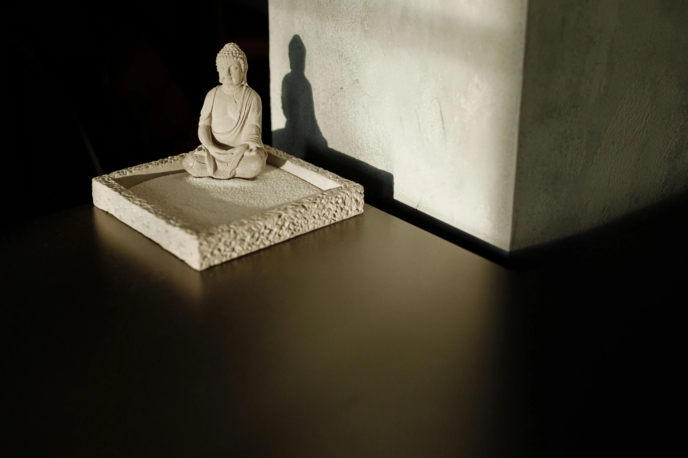 a small white statue sitting on top of a table