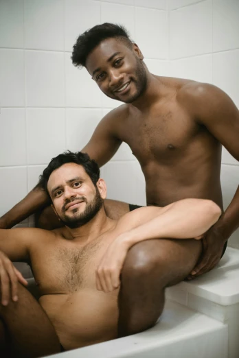 two black men pose together in the bathroom