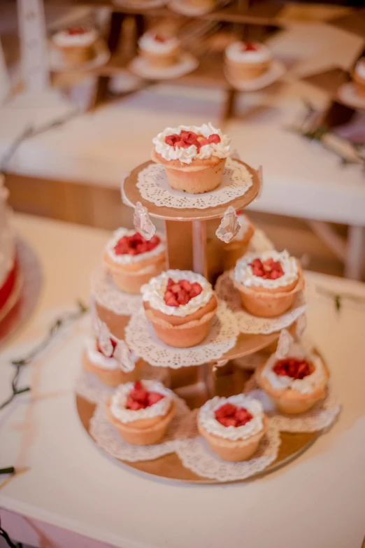 many cupcakes with white lace on a table