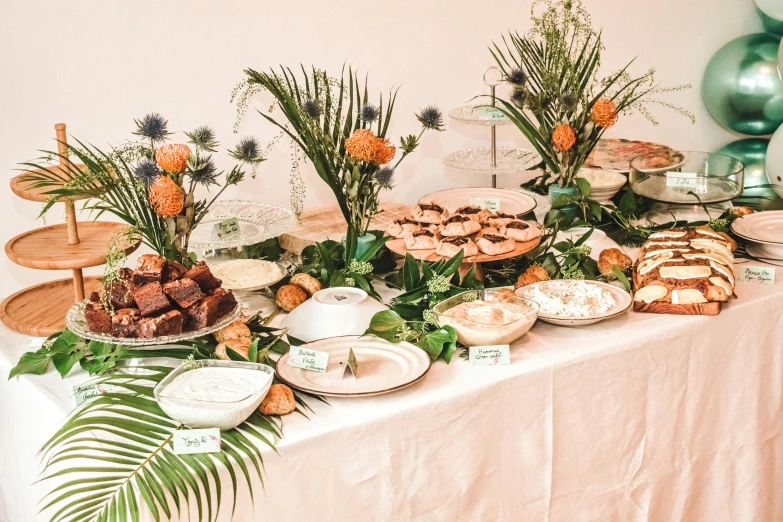 a table has food on it with green and gold decorations