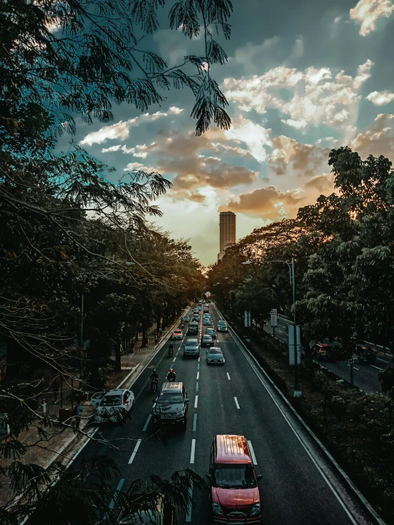 a long city street with cars driving through it