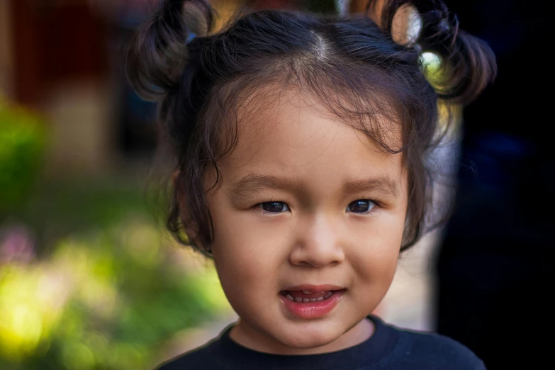 a young child in an odd style headband with large hair