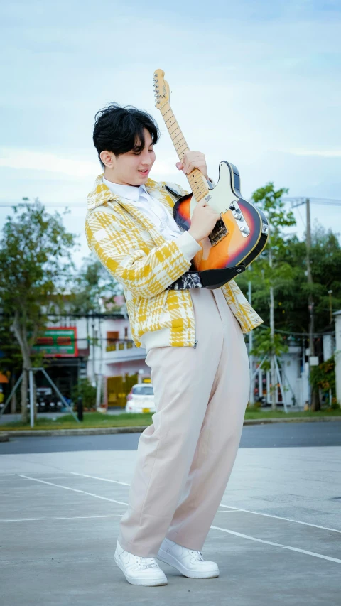 a man holding an electric guitar in his hand