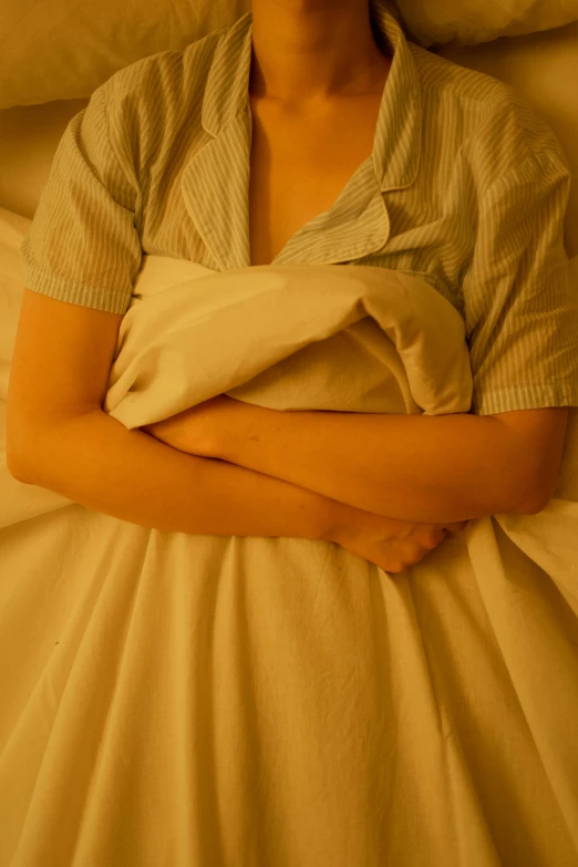 a woman in bed with her arms crossed