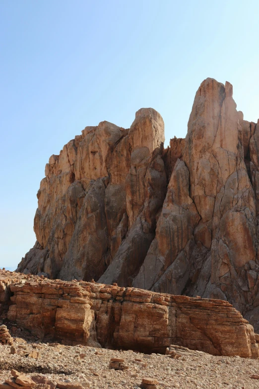 a mountain that has a rock formation with rocks in front of it