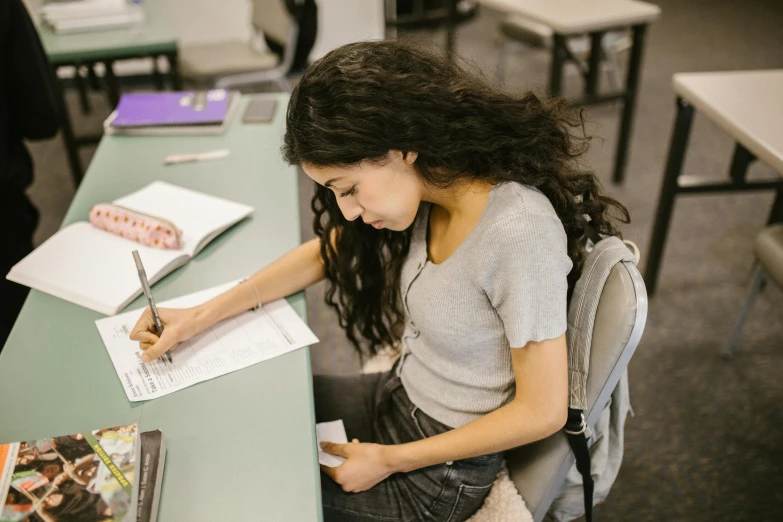 the young woman is working on her homework