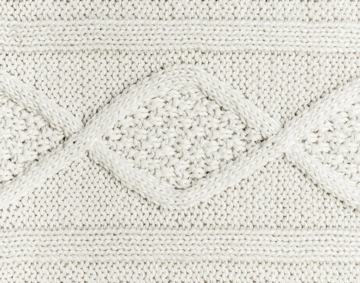 white wool knitting with diamonds and points of stitch