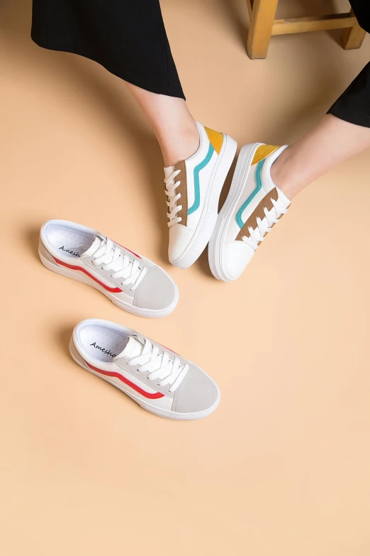 a woman in white and blue sneakers standing next to her legs