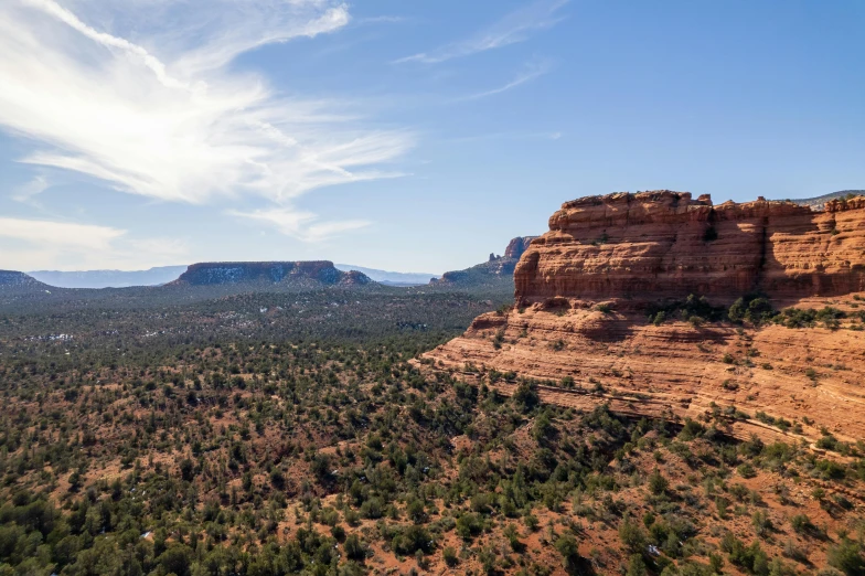 the view of some red rock formations and trees