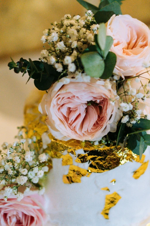 some flowers and other plants on top of a cake