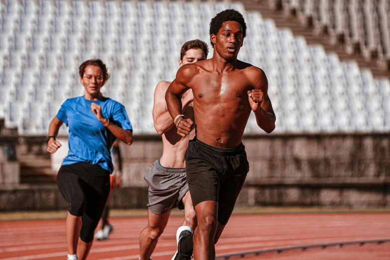 a group of young men running on top of a track