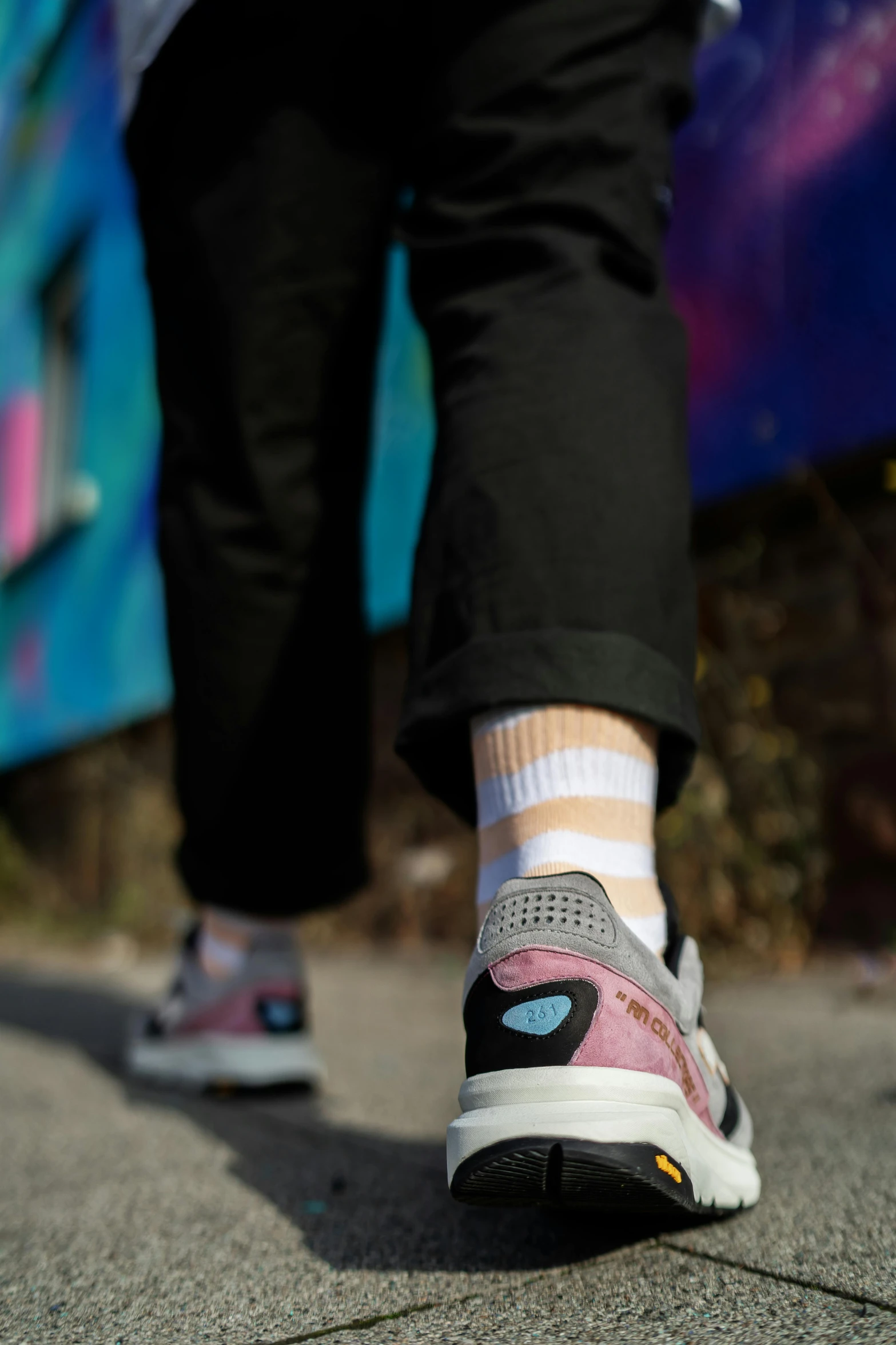 the bottom of someone's sneakers on the pavement