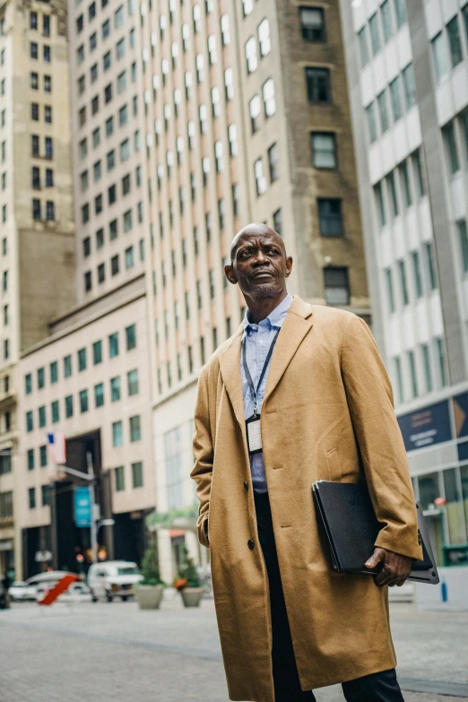 a man standing on a street in front of tall buildings