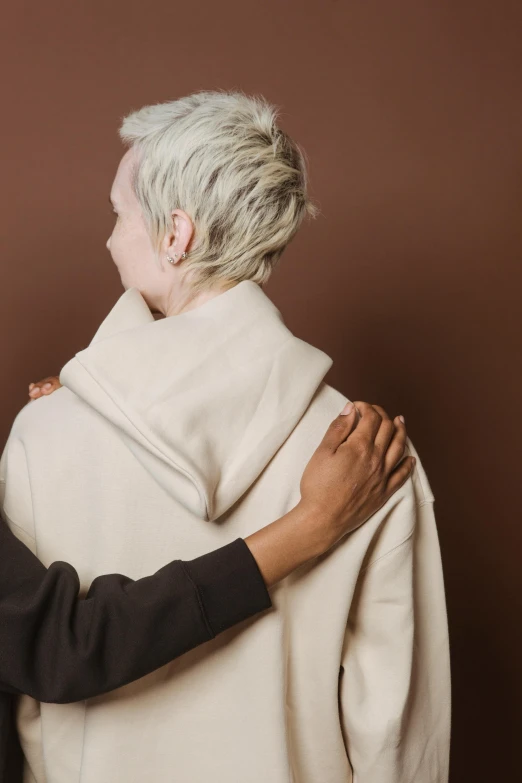 a woman with white hair wearing a white sweater