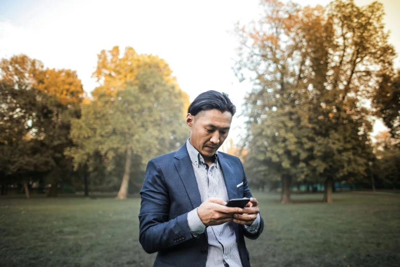 a man wearing a suit looking at his phone