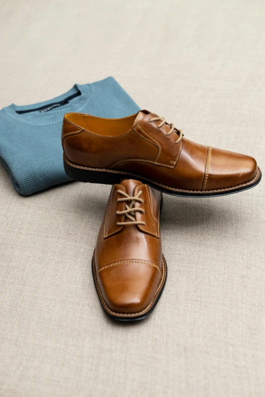 an old pair of brown shoes and a blue handkerchief