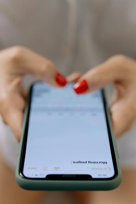 a woman holding onto a phone in her hands