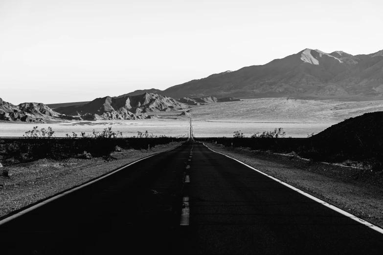 a road stretches into the distance on a mountain side