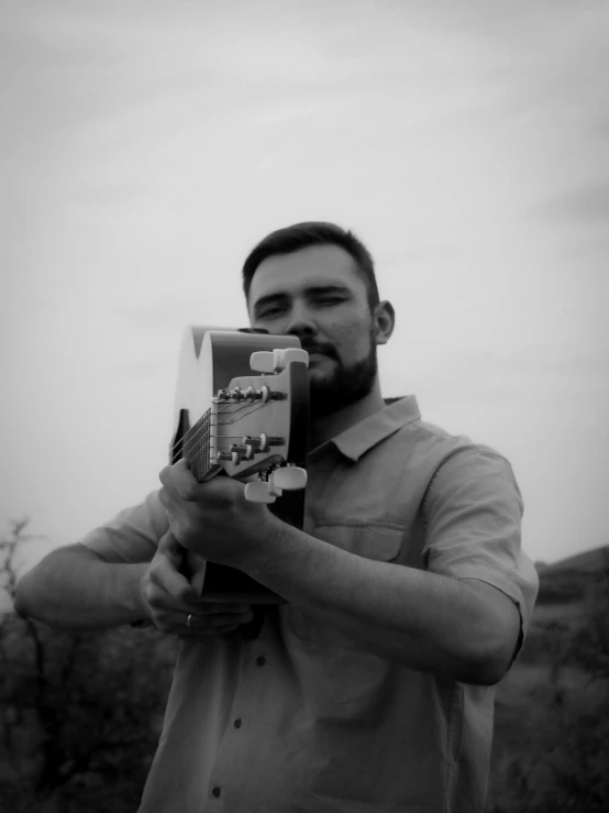 a man is holding a small model in his hands