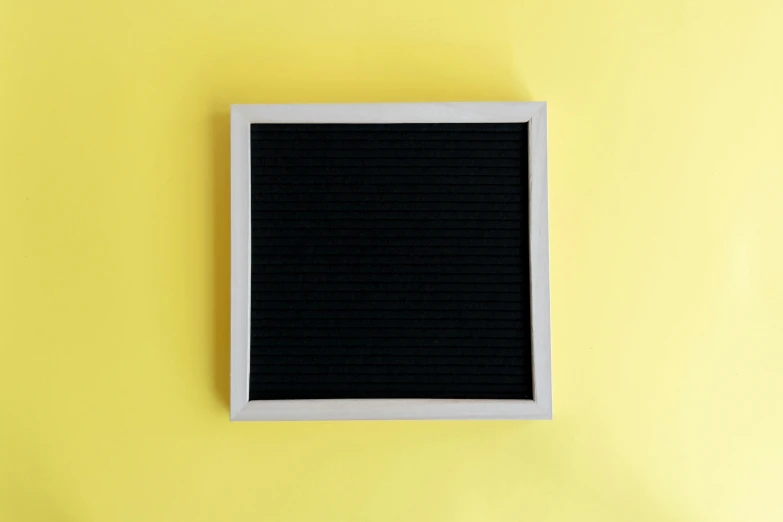 a window is mounted to a wall on a yellow background