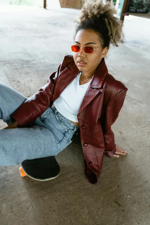 a young woman is sitting on the ground