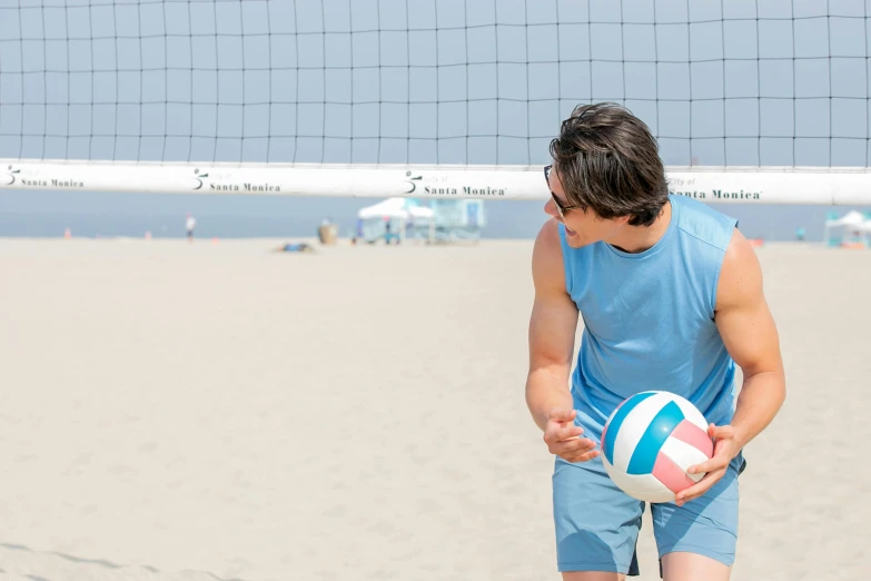 man with a beach ball in his hand on the beach