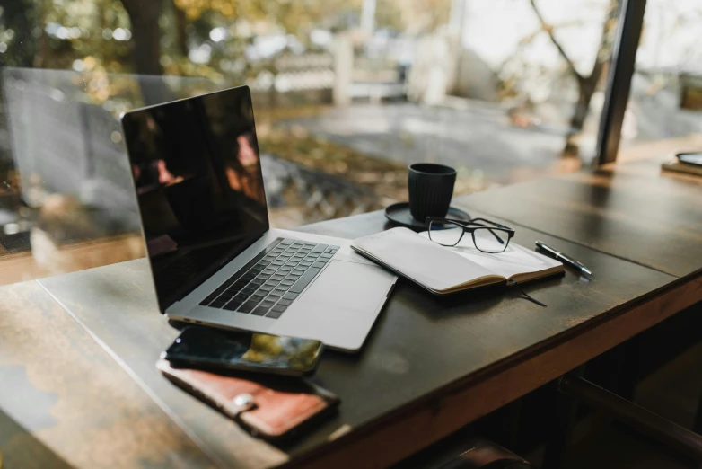 a computer and cup sit on the table