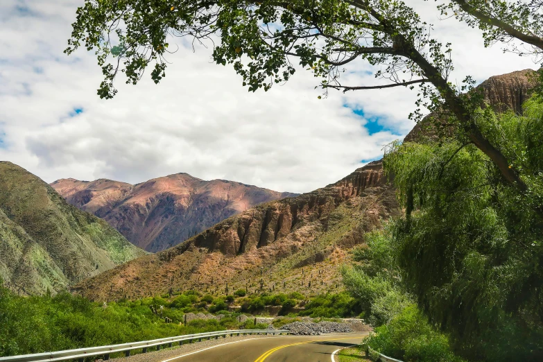 the curve of a winding road leads to a hill side