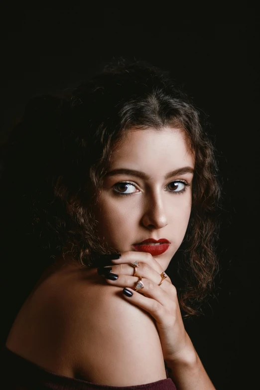 a woman posing for a picture with her hands on her chin