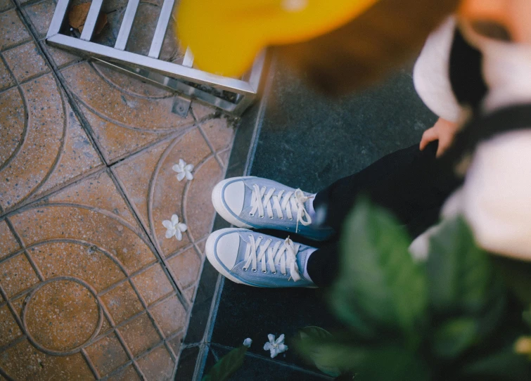 a person sitting on a porch with their feet up