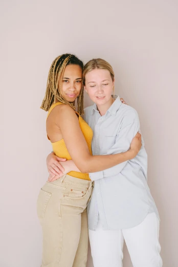 two teenage girls are hugging and posing together