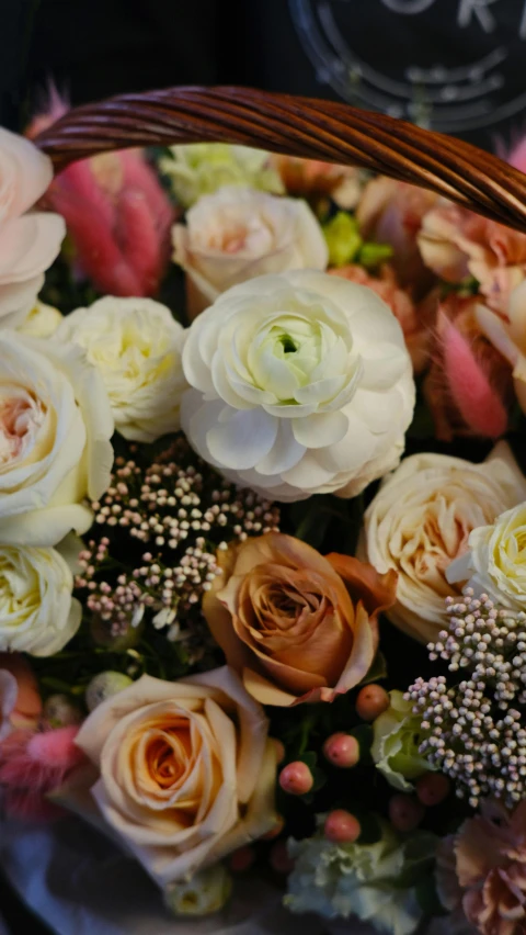 a basket with pink and white roses on it