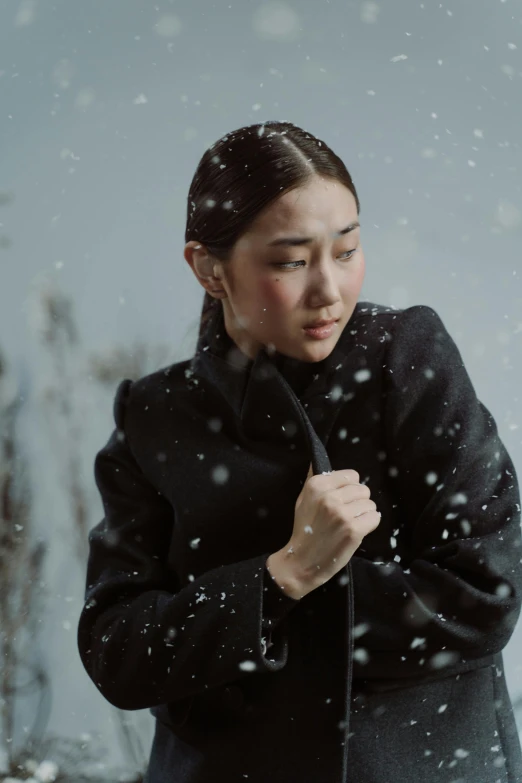 a woman holds an umbrella in the snow