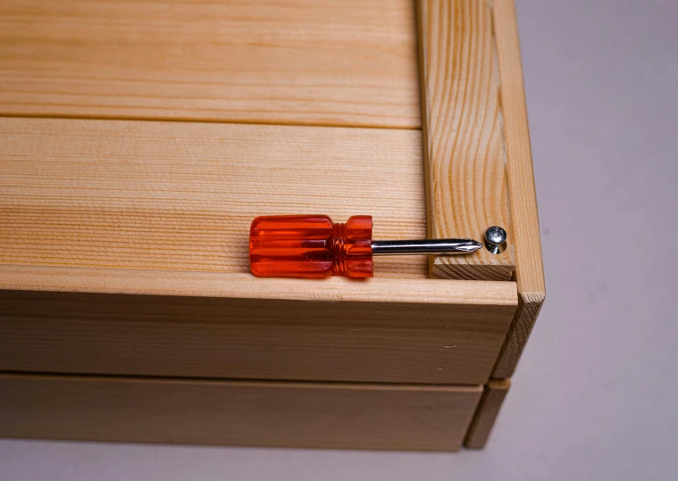 there is a small glass drawer on top of the wood