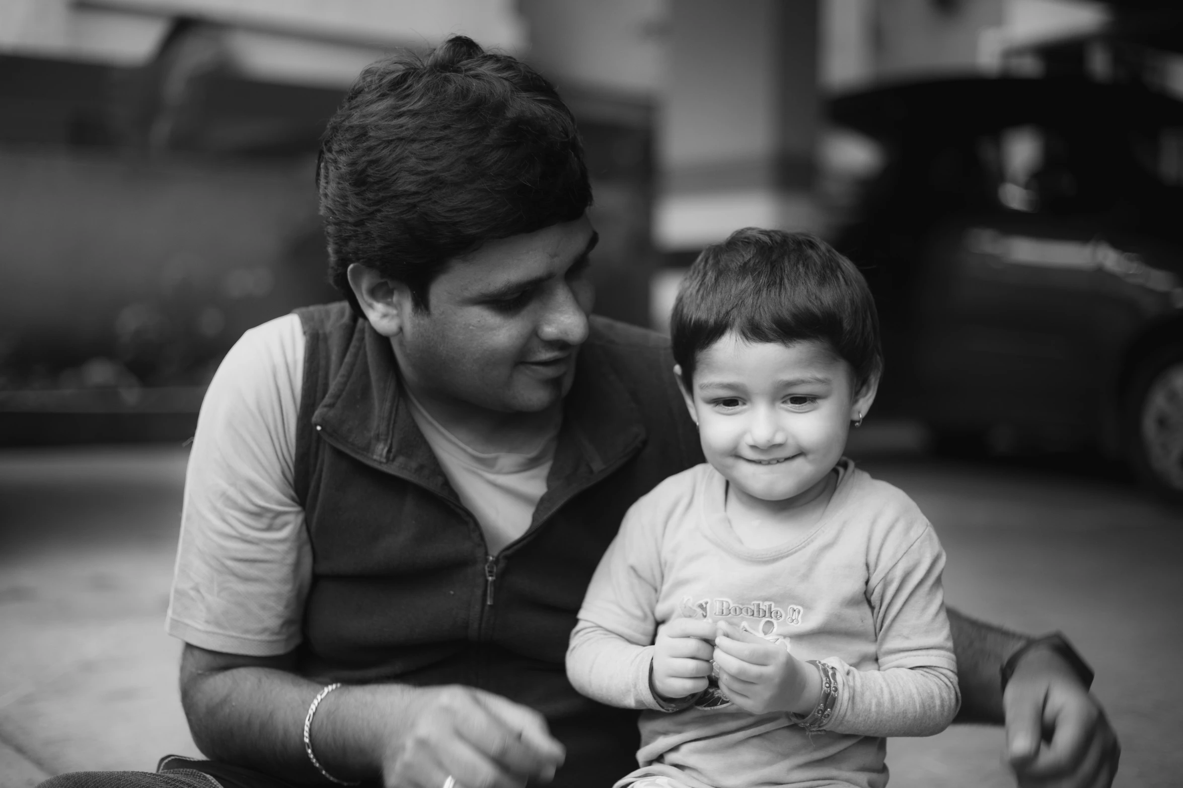 a woman sitting with a young child and  food