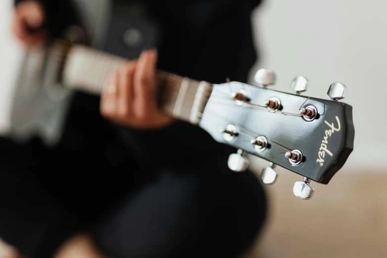 a man playing an acoustic guitar in a room