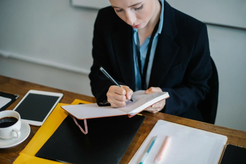 a woman is looking down at her paper