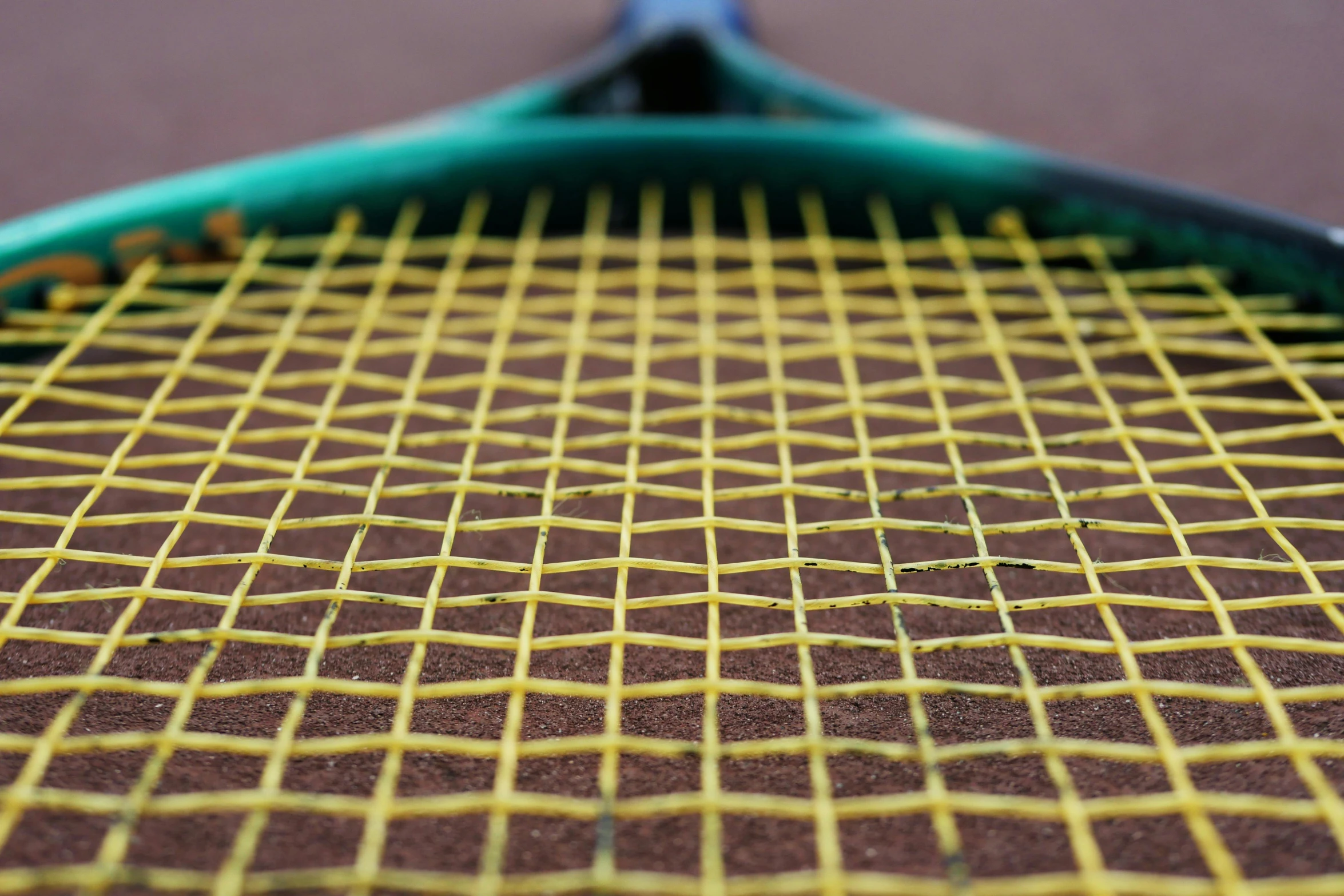 the tennis racket is painted with yellow and brown