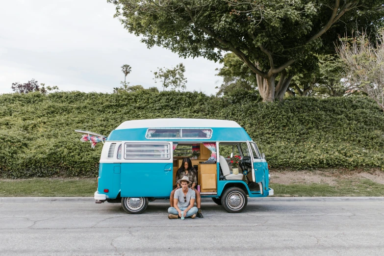 a blue bus with two women in it on the side