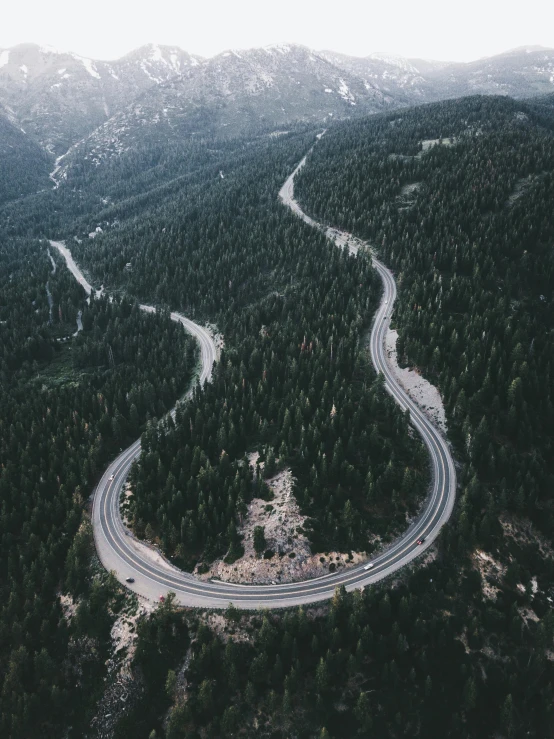 an aerial view of a highway in the mountains