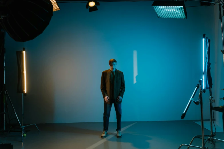 a man standing in front of a camera in a dark room