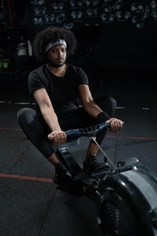 a young man sitting on top of a machine