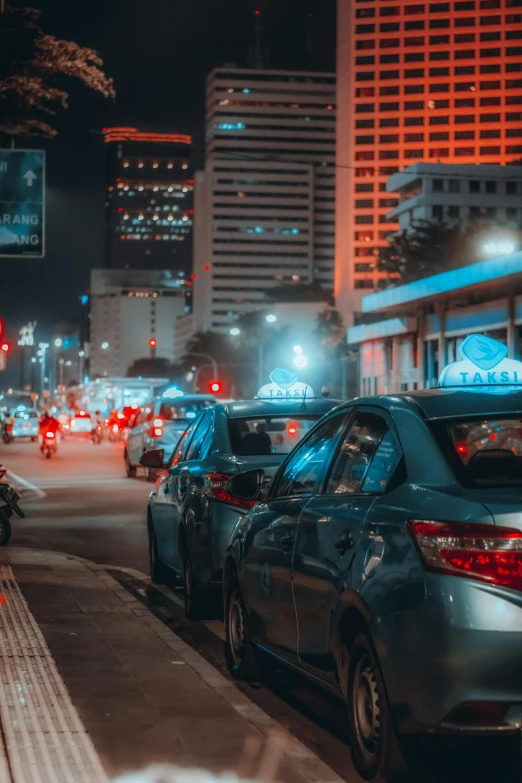 city at night with cars, motorcycles, and building lights