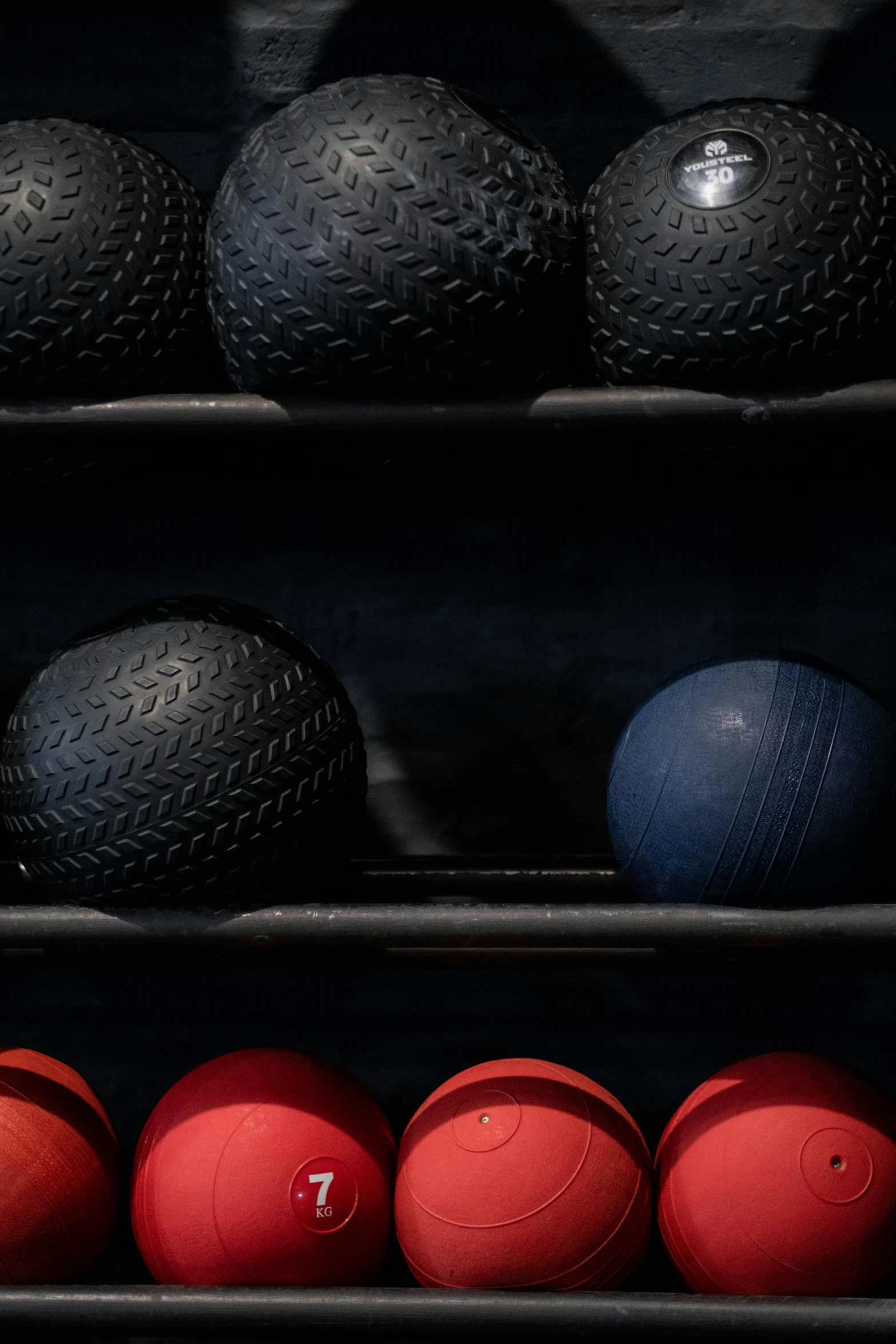 a display case holds several different colored rubber balls