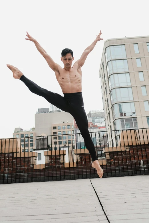 a man is dancing on a small stilt