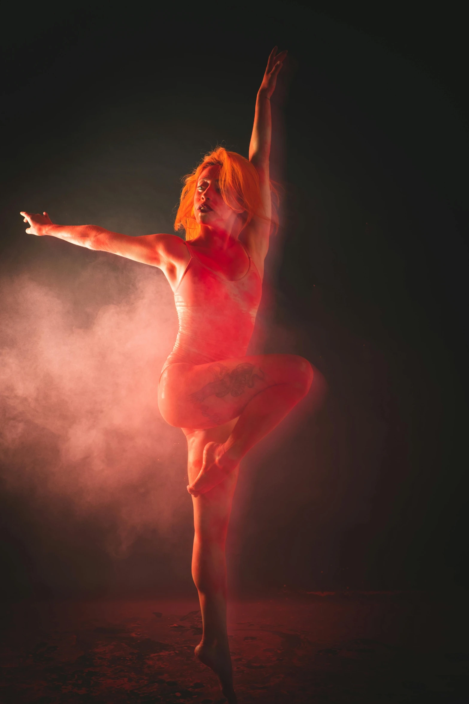 the dancer is posing with her arms in the air