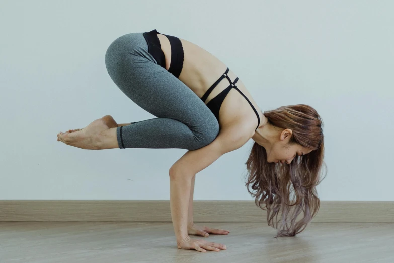 a woman is doing yoga poses in the air