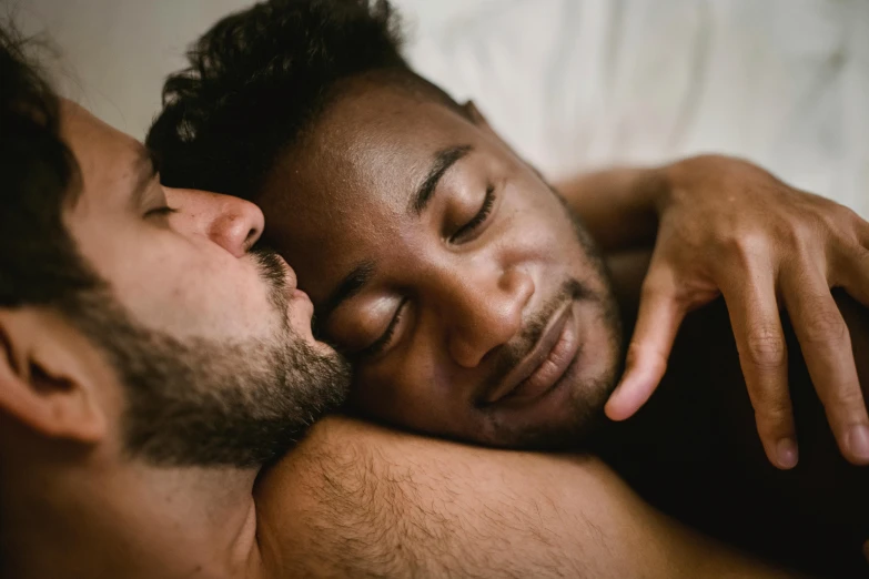 the man in bed is sleeping peacefully with his hand on the chest