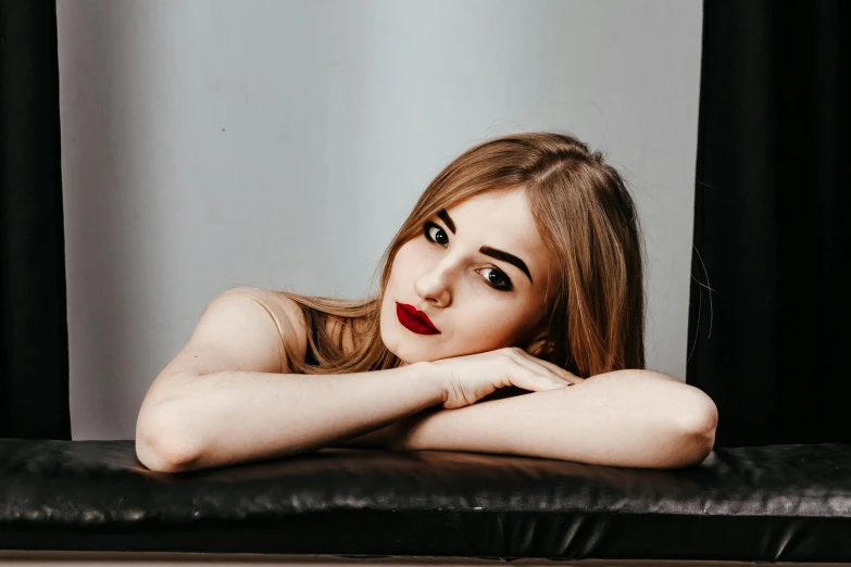 an image of a woman with red lips sitting